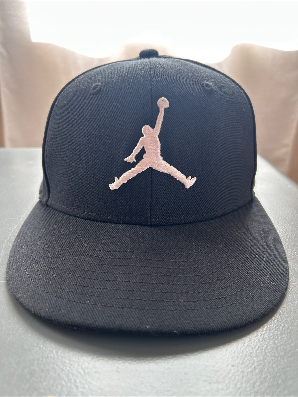 Jordan Men’s Pro Jump-man Black Snapback Hat with White Embroidered Logo. Small.